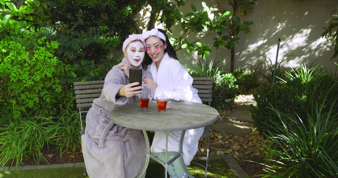 Mother and Daughter Relaxing with Skincare on Patio