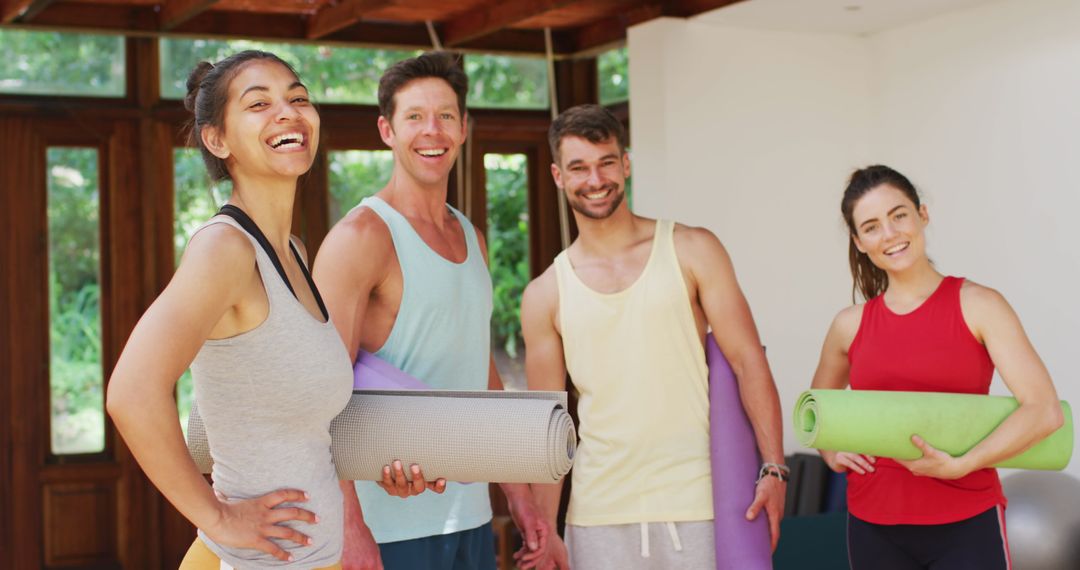 Diverse Group Enjoying Yoga Class with Rollup Mats and Smiles