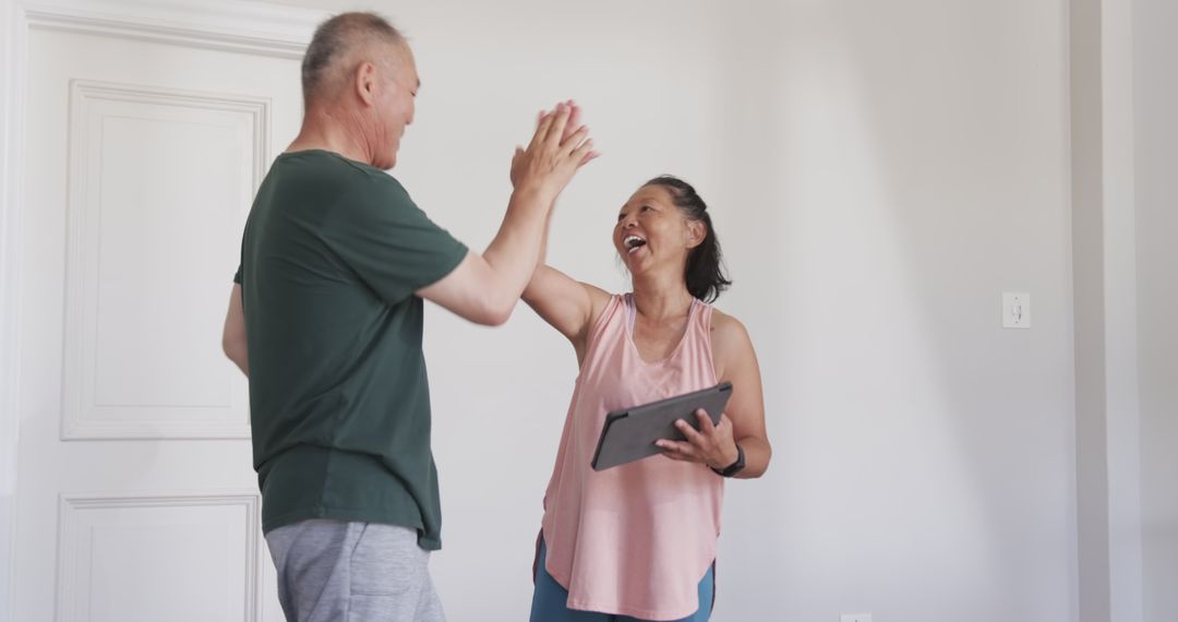 Senior Couple Bonding Over Tablet Using Technology at Home