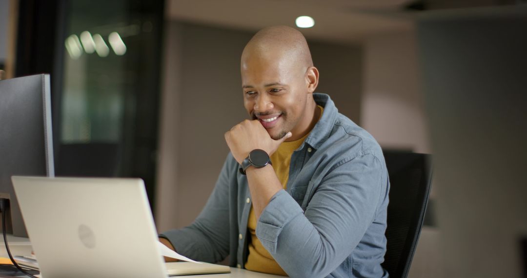 African American Man Working on Laptop in Modern Office Workspace