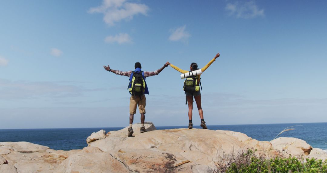 Adventurous Couple Embracing Freedom on Coastal Hiking Trip