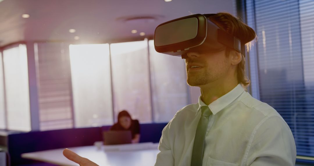 Young Businessman Experiencing Virtual Reality in Office Environment