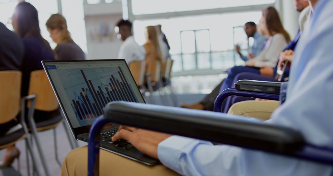 Businessman Analyzing Graph on Laptop During Seminar
