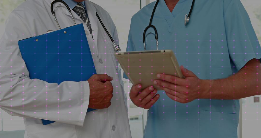 Doctors Discussing with Digital Tablet and Clipboard in Hospital