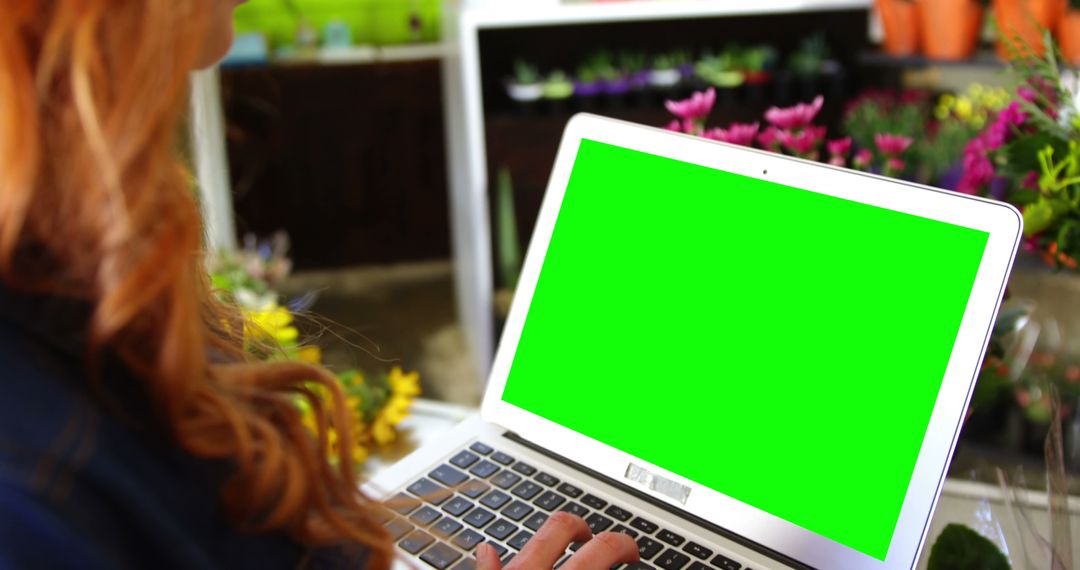 Woman Using Laptop With Green Screen in Floral Shop - Free Images, Stock Photos and Pictures on Pikwizard.com