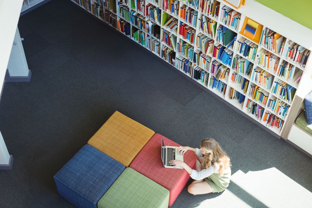 Child Studying on Laptop in Bright Modern Library