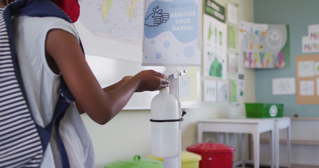 Student Using Hand Sanitizer Dispenser in Classroom for Hygiene - Free Images, Stock Photos and Pictures on Pikwizard.com