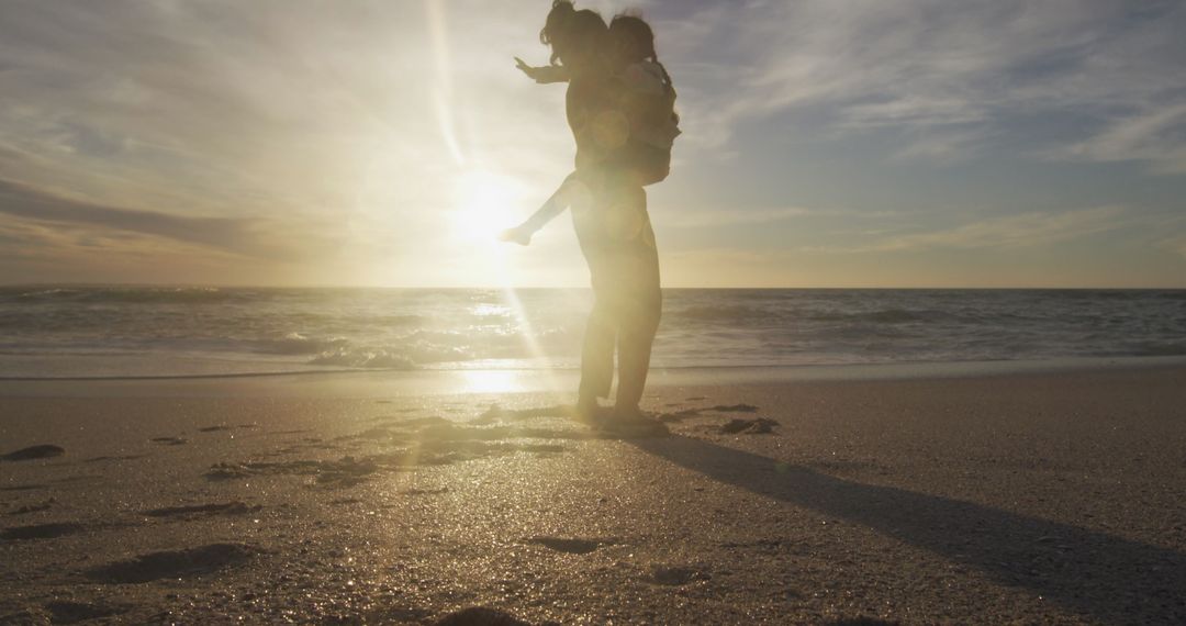 Mother Playing with Daughter at Sunset Beach