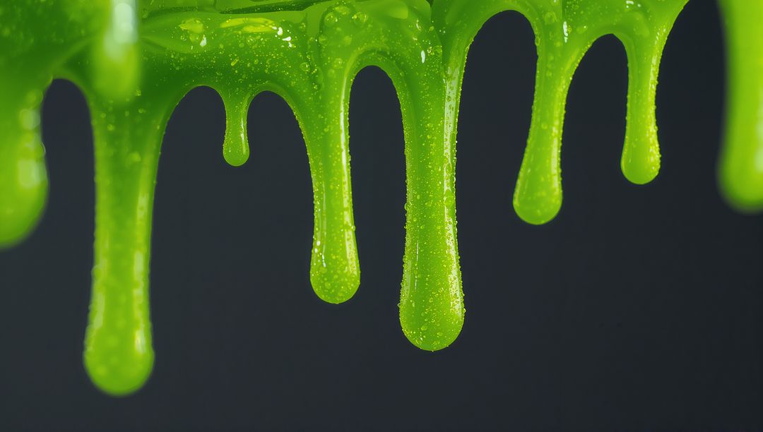 Closeup of Dripping Green Slime with Glossy Texture
