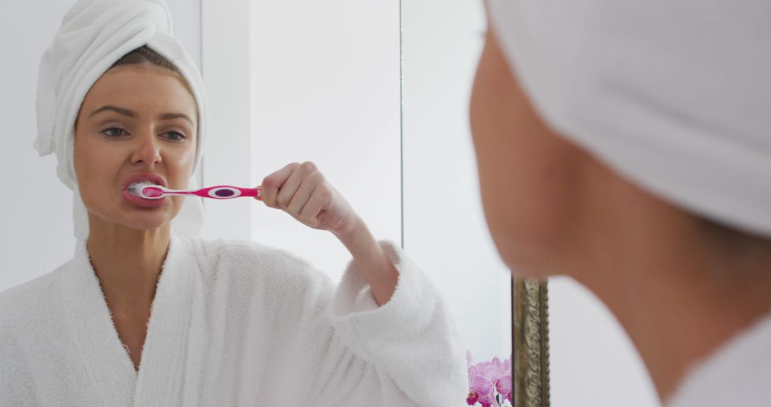 Woman Brushing Teeth in Mirror with Towel on Head - Free Images, Stock Photos and Pictures on Pikwizard.com