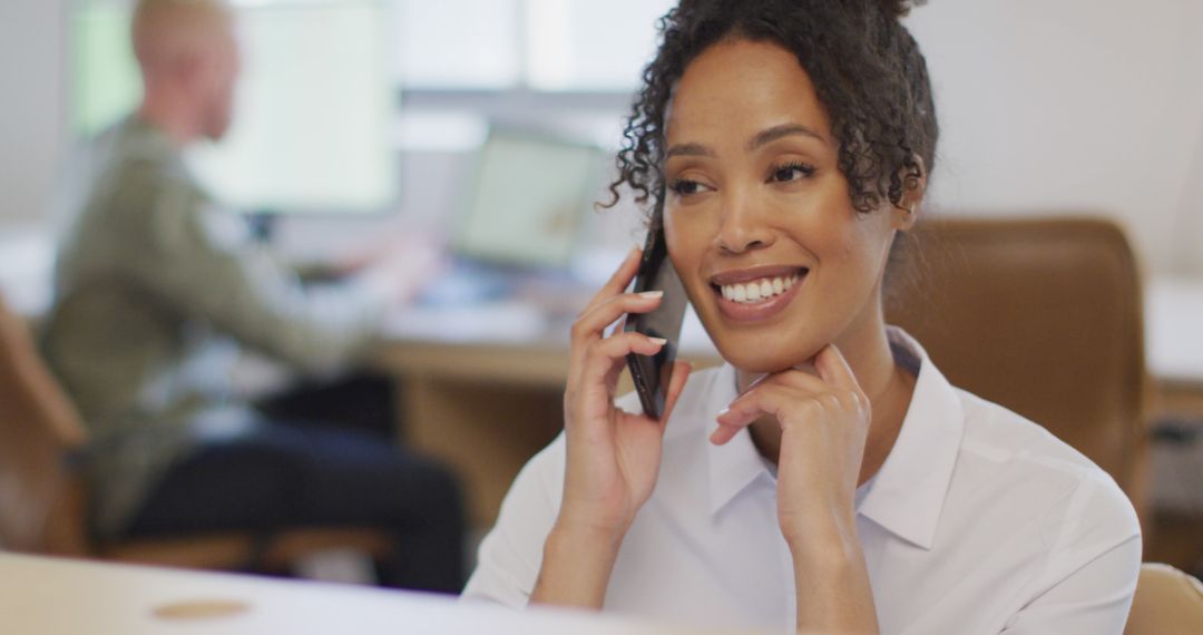 Smiling Businesswoman Taking Phone Call in Modern Office - Free Images, Stock Photos and Pictures on Pikwizard.com