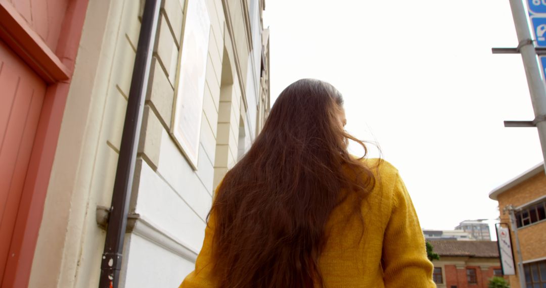 Woman with Long Hair Walking in Urban Area - Free Images, Stock Photos and Pictures on Pikwizard.com