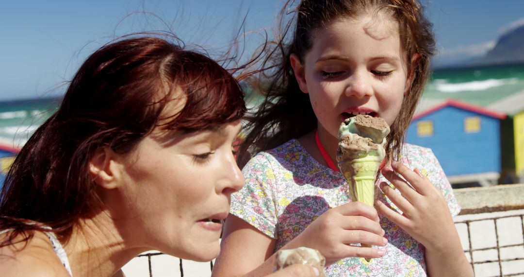 Mother and Daughter Enjoying Ice Cream on Beach - Free Images, Stock Photos and Pictures on Pikwizard.com