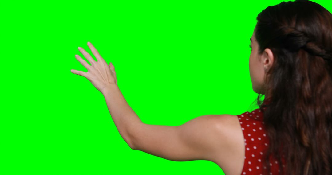 Woman Interacting with Invisible Display Against Green Screen