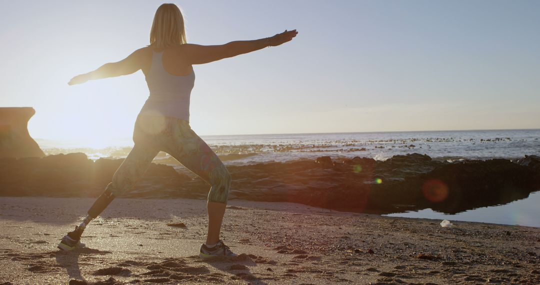 Woman with Prosthetic Leg Practicing Yoga on Beach at Sunset - Free Images, Stock Photos and Pictures on Pikwizard.com