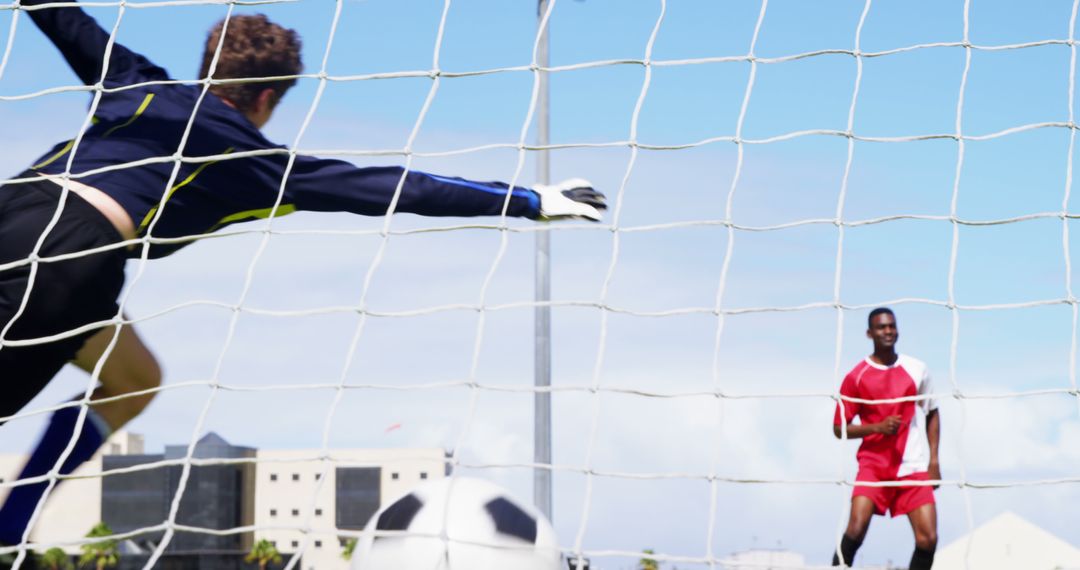 Goalkeeper Trying to Block Ball During Soccer Match - Free Images, Stock Photos and Pictures on Pikwizard.com