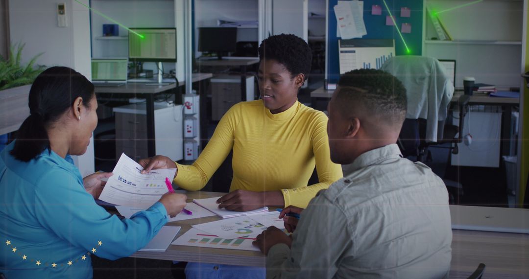 Diverse Team Analyzing Sales Report in Modern Office