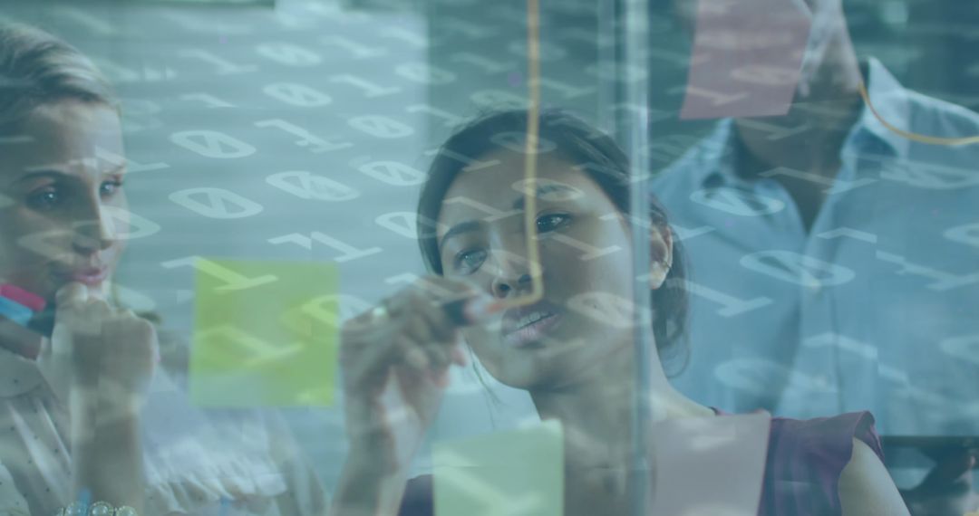 Diverse business team collaborating with binary code overlay