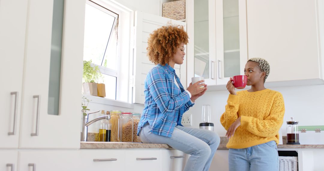 Two Friends Enjoying Coffee in Modern Kitchen - Free Images, Stock Photos and Pictures on Pikwizard.com