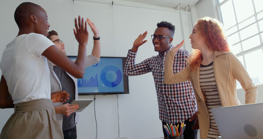 Diverse Business Team Celebrating Project Success with High Fives