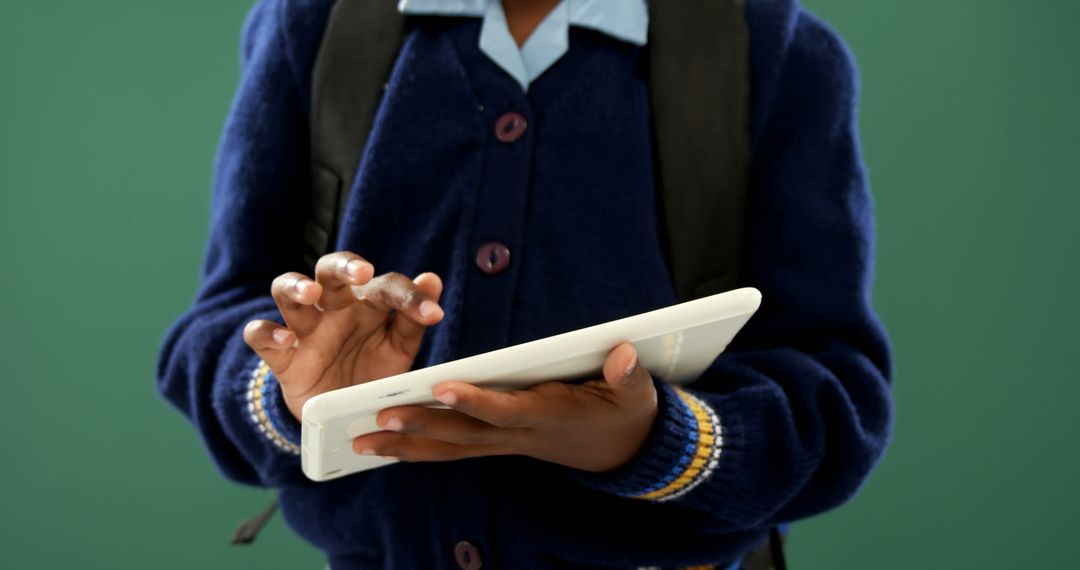 Student Using Tablet for Learning in School Uniform