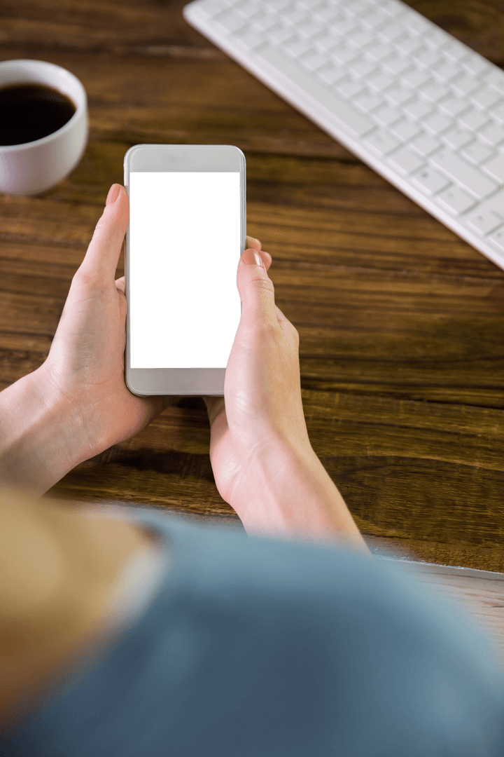 Transparent Smartphone in Hands with Wooden Desk Background