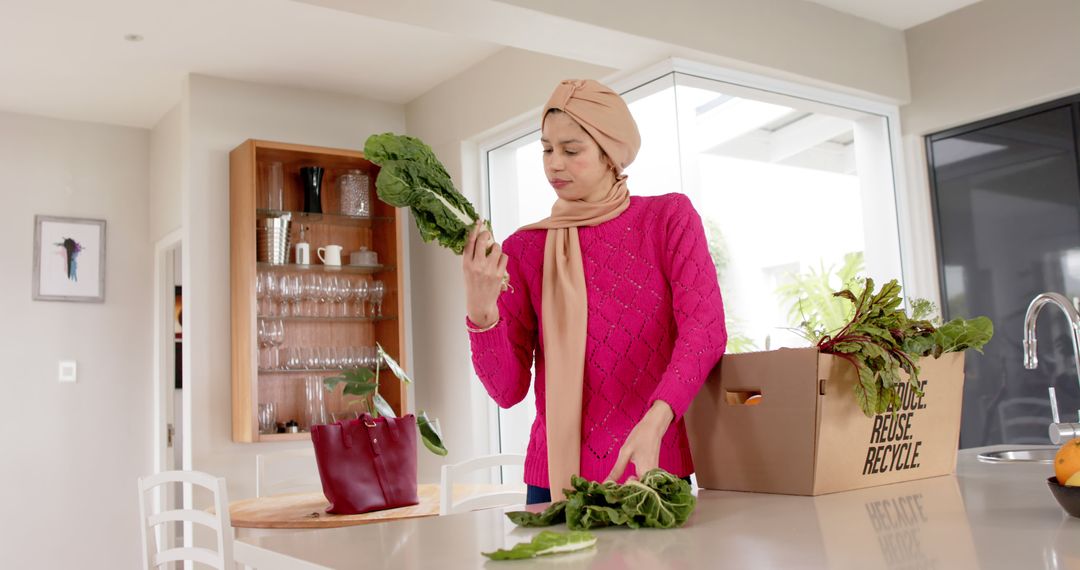 Muslim Woman Unpacking Groceries in Modern Kitchen - Free Images, Stock Photos and Pictures on Pikwizard.com