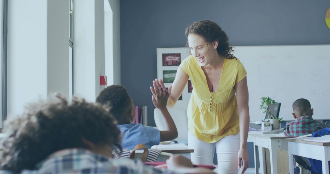 Teacher High-Fiving Student in Bright Classroom Promoting Positive Learning and Engagement