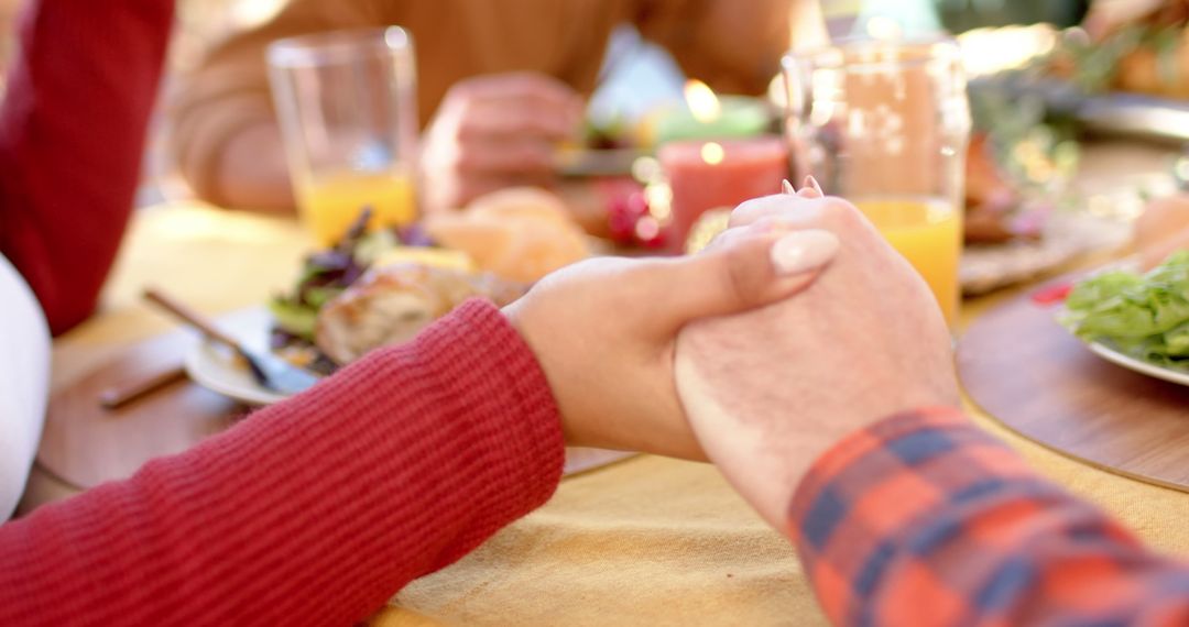 Close-up of People Holding Hands at Outdoor Meal - Free Images, Stock Photos and Pictures on Pikwizard.com