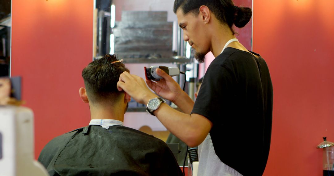 Barber trimming customer's hair in modern barbershop - Free Images, Stock Photos and Pictures on Pikwizard.com