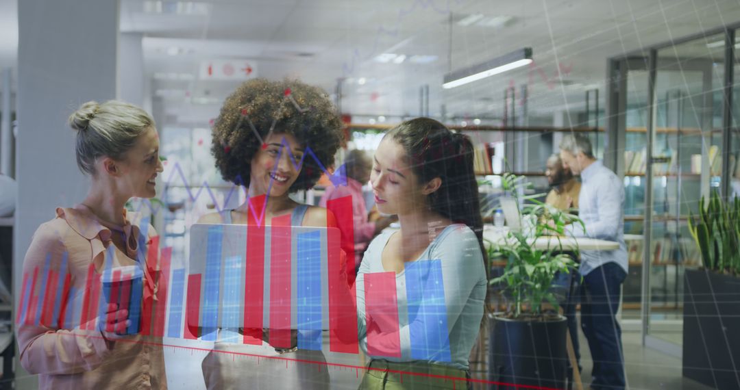 Businesswomen Analyzing Graphs on Digital Screen in Modern Office - Free Images, Stock Photos and Pictures on Pikwizard.com