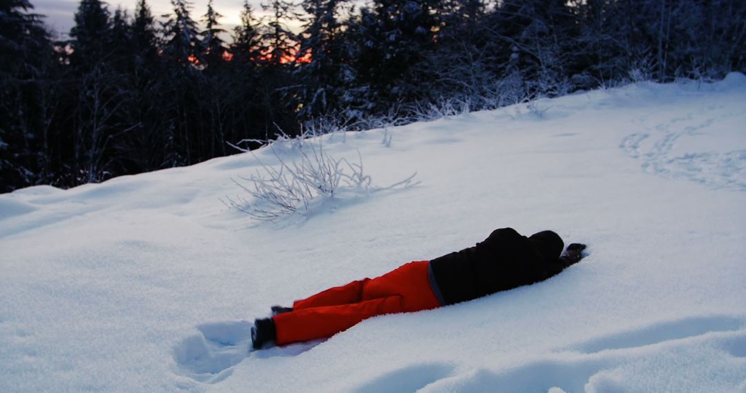 Person Lying in Snowy Landscape at Dusk - Free Images, Stock Photos and Pictures on Pikwizard.com