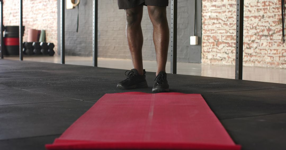 Determined Athlete Standing on Red Workout Mat Ready for Training