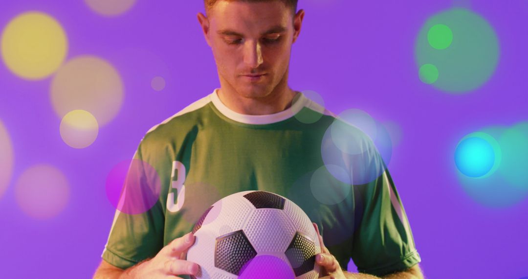 Focused Soccer Player Holding Ball with Vibrant Digital Effects