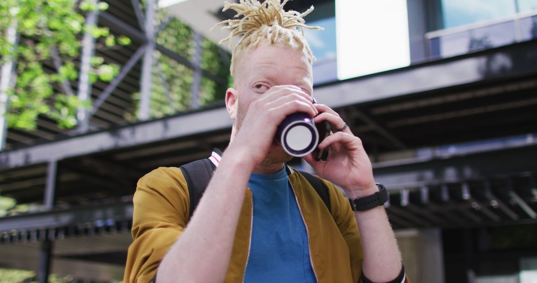 Urban Albino Man with Dreadlocks Enjoying Coffee and Chatting - Free Images, Stock Photos and Pictures on Pikwizard.com