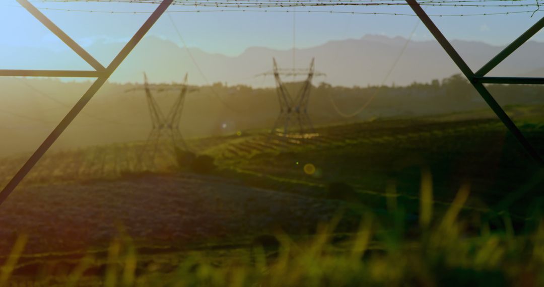 Serene Countryside Landscape at Sunrise with Power Lines and Towers - Free Images, Stock Photos and Pictures on Pikwizard.com