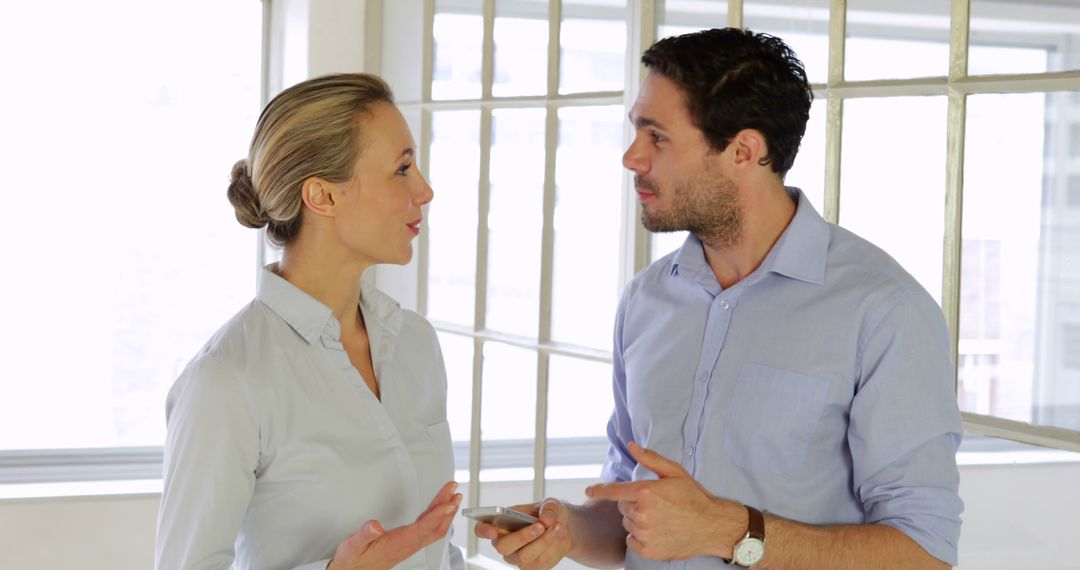 Happy Business Conversation in Bright Office Environment