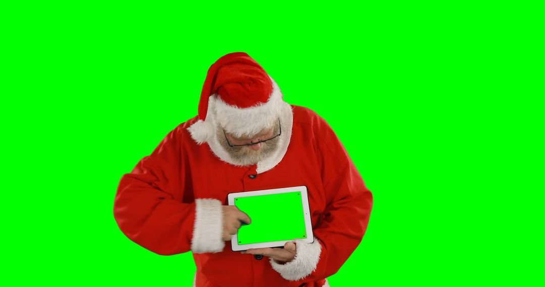 Santa Claus using digital tablet with green screen isolated on green background - Free Images, Stock Photos and Pictures on Pikwizard.com