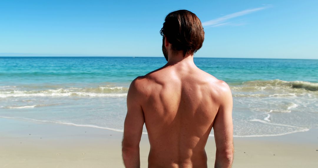 Rear view of man standing on beach 4k - Free Images, Stock Photos and Pictures on Pikwizard.com