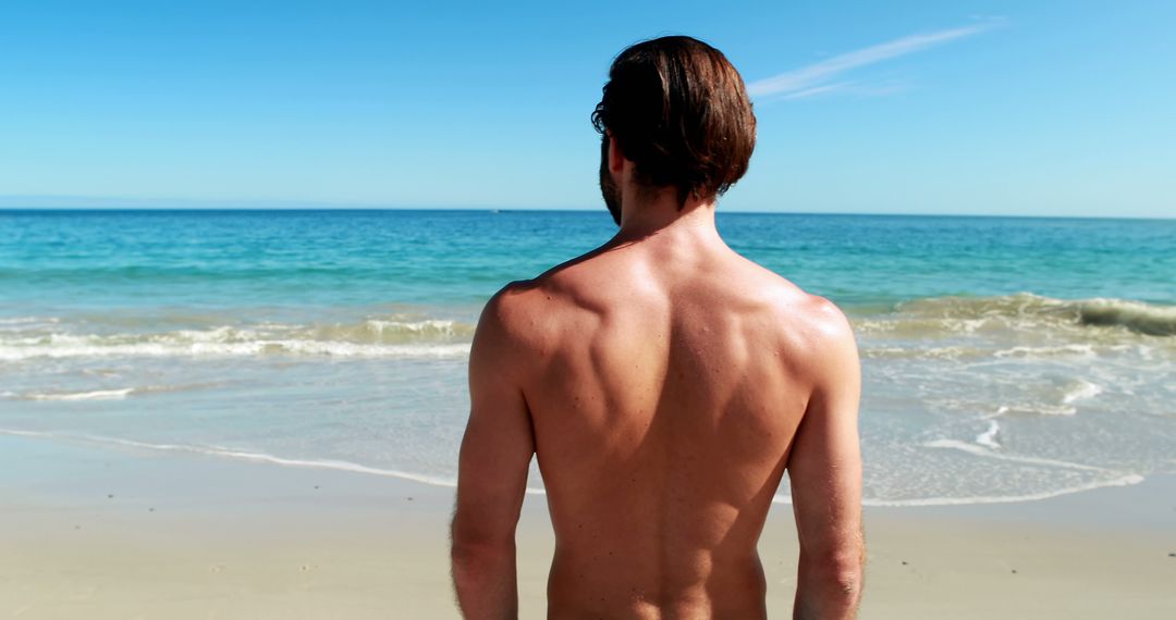 Man Enjoying Sunny Day at Tranquil Beach - Free Images, Stock Photos and Pictures on Pikwizard.com