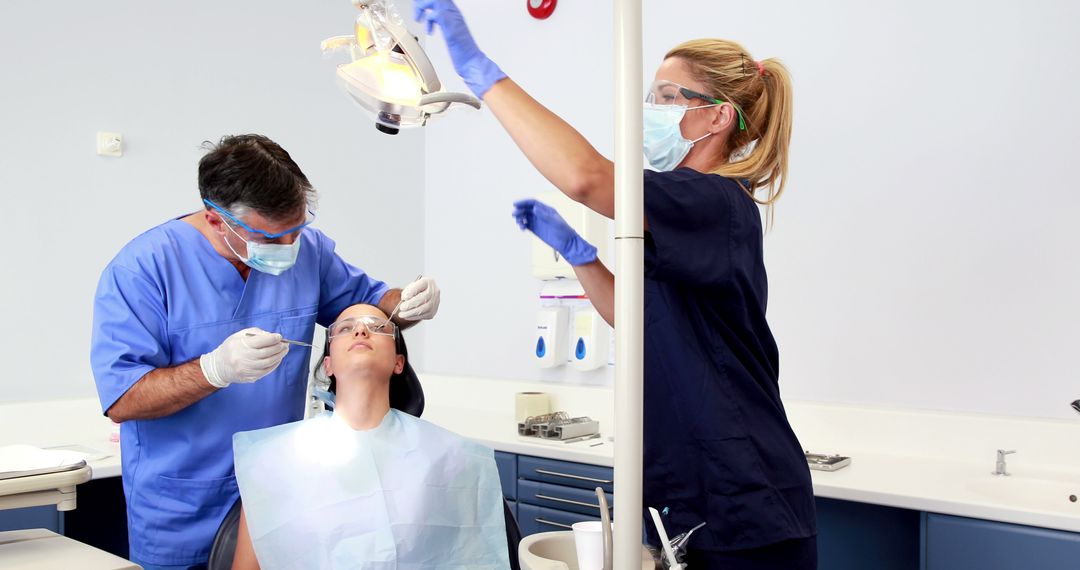 Dentists Examining Patient with Dental Tools in Clinic - Free Images, Stock Photos and Pictures on Pikwizard.com