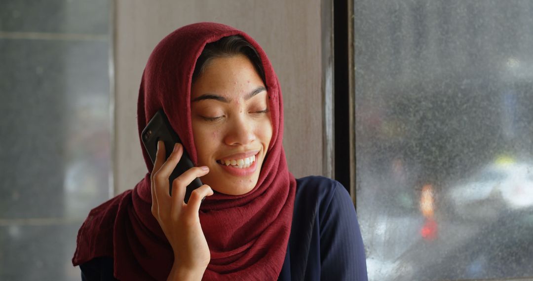 Smiling Hijab-Clad Woman Talking on Smartphone - Free Images, Stock Photos and Pictures on Pikwizard.com