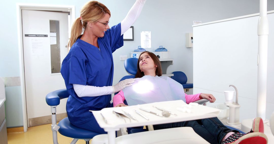 Dentist Conducting Examination for Young Patient in Modern Clinic - Free Images, Stock Photos and Pictures on Pikwizard.com