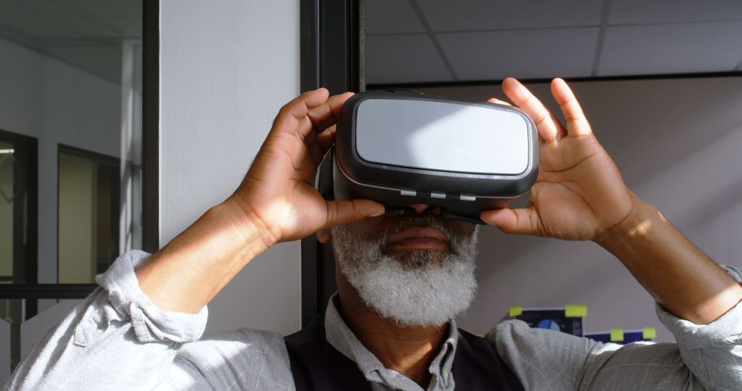 Senior Man Experiencing Virtual Reality with VR Headset Indoors - Free Images, Stock Photos and Pictures on Pikwizard.com