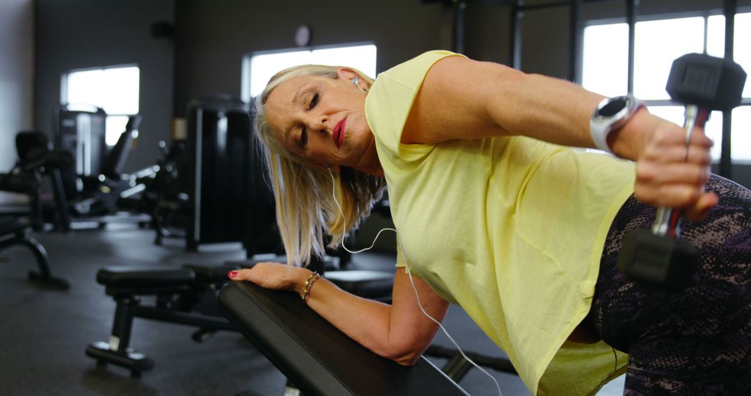 Senior Woman Working Out With Dumbbells in Modern Gym - Free Images, Stock Photos and Pictures on Pikwizard.com