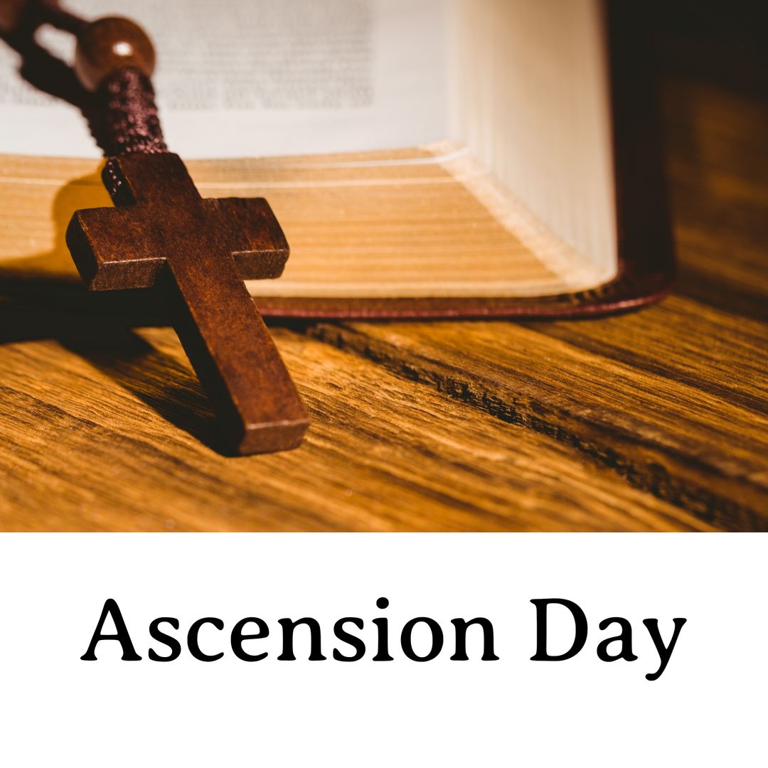 Wooden Cross Resting on Open Bible Symbolizing Ascension Day