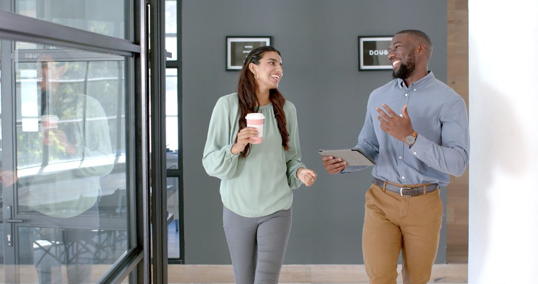 Colleagues Walking and Discussing Business with Tablet and Coffee