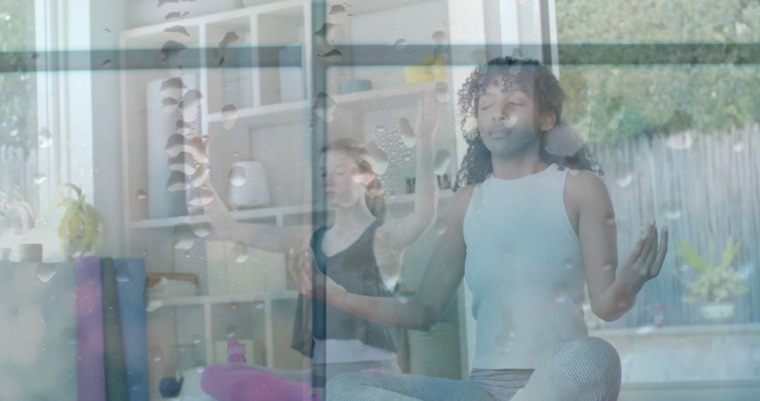 Meditating Teens Behind Raindrop-Covered Window Indicating Tranquility