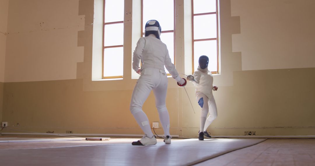 Fencing Practice Between Two Athletes in Gloves and Mask - Free Images, Stock Photos and Pictures on Pikwizard.com