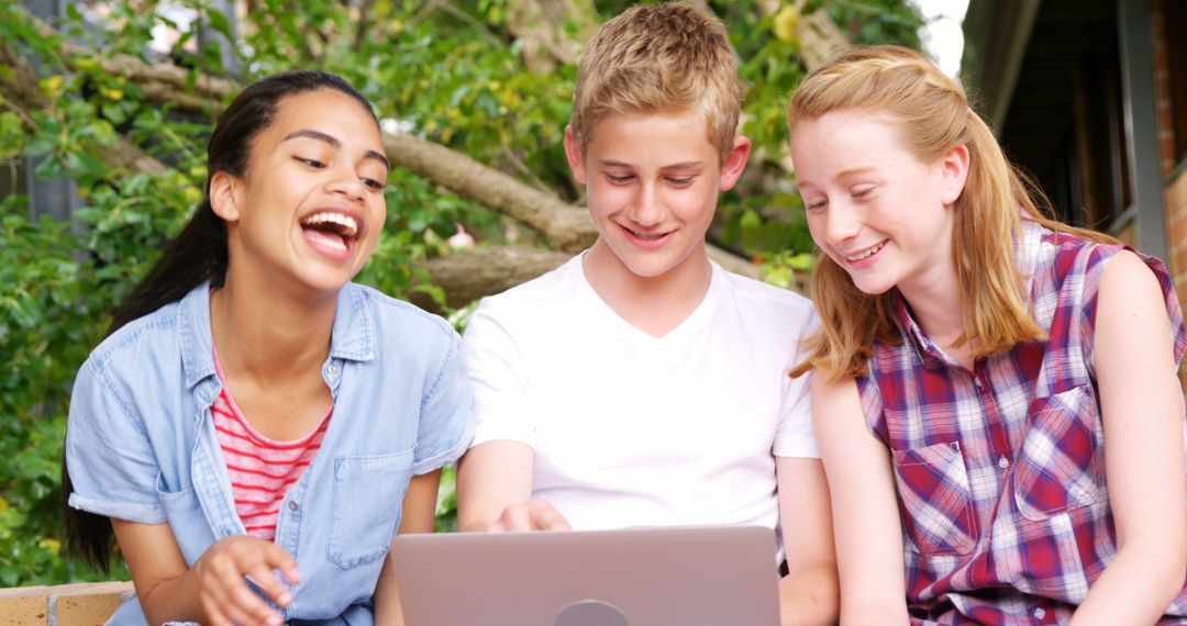 Diverse Teenagers Enjoying Laptop Outdoors - Free Images, Stock Photos and Pictures on Pikwizard.com